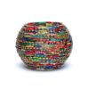 Introducing the Suport pentru Lumânări din Sticlă Mozaic cu Linii: a spherical, colorful, and multi-textured decorative bowl. Prezintă straturi strâns înfășurate de benzi vibrante cu model în roșu, verde, albastru, galben și alte culori. Impodobit cu accente aurii mici și linii complicate care amintesc de un design mozaic sticlă, creează o afișare vizuală plină de viață.